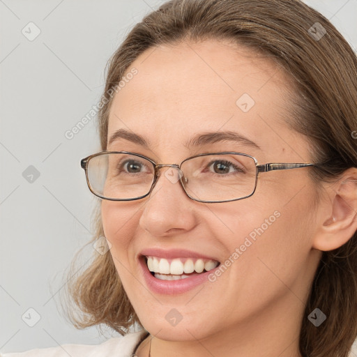 Joyful white adult female with long  brown hair and brown eyes