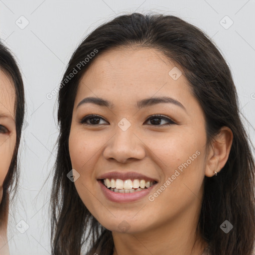 Joyful latino young-adult female with long  brown hair and brown eyes