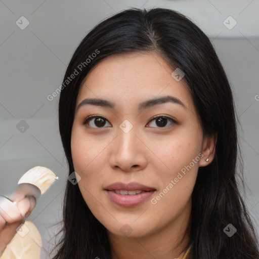 Joyful asian young-adult female with long  black hair and brown eyes