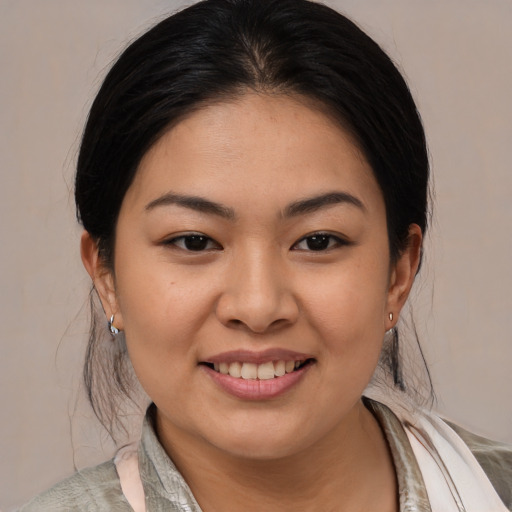Joyful asian young-adult female with medium  brown hair and brown eyes