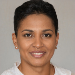 Joyful latino young-adult female with short  brown hair and brown eyes