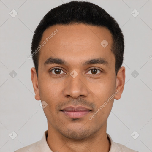 Joyful latino young-adult male with short  black hair and brown eyes