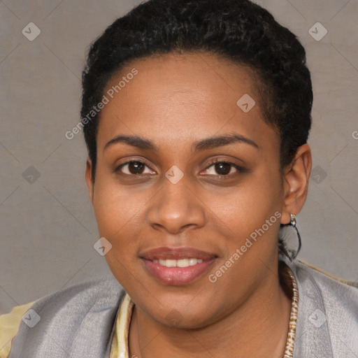 Joyful black young-adult female with short  black hair and brown eyes