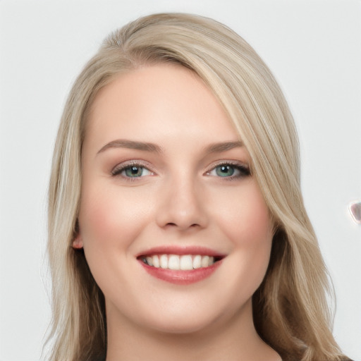 Joyful white young-adult female with long  brown hair and blue eyes