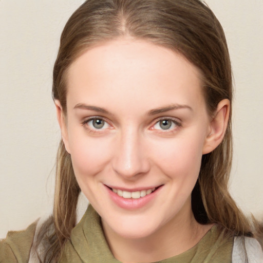 Joyful white young-adult female with long  brown hair and grey eyes