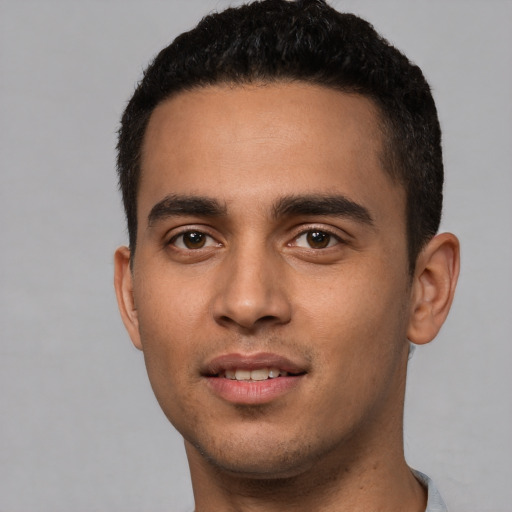 Joyful white young-adult male with short  black hair and brown eyes