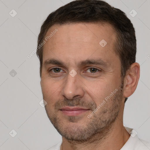 Joyful white adult male with short  brown hair and brown eyes