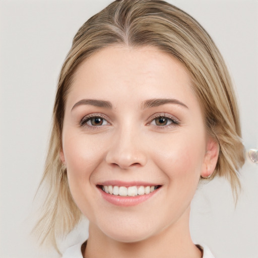 Joyful white young-adult female with medium  brown hair and blue eyes