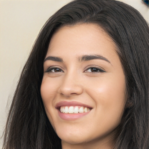 Joyful latino young-adult female with long  black hair and brown eyes