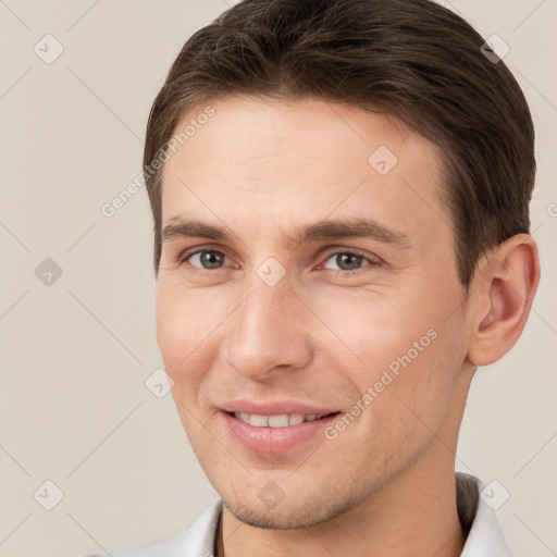 Joyful white young-adult male with short  brown hair and brown eyes