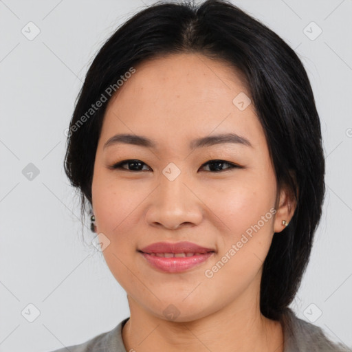 Joyful asian young-adult female with medium  black hair and brown eyes