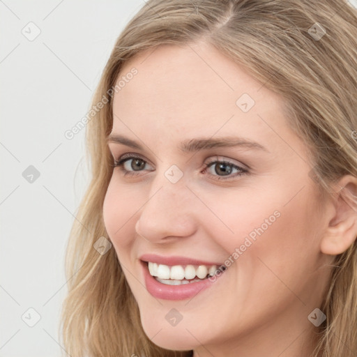 Joyful white young-adult female with long  brown hair and blue eyes