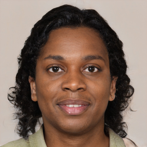 Joyful black young-adult female with medium  black hair and brown eyes