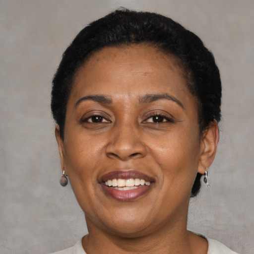 Joyful latino adult female with short  brown hair and brown eyes
