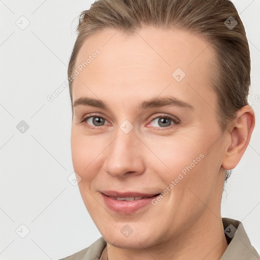 Joyful white young-adult female with short  brown hair and brown eyes