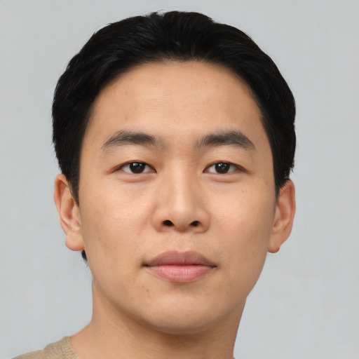 Joyful asian young-adult male with short  black hair and brown eyes
