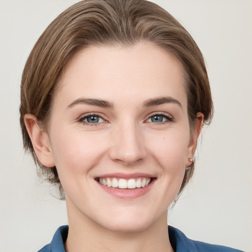 Joyful white young-adult female with medium  brown hair and grey eyes