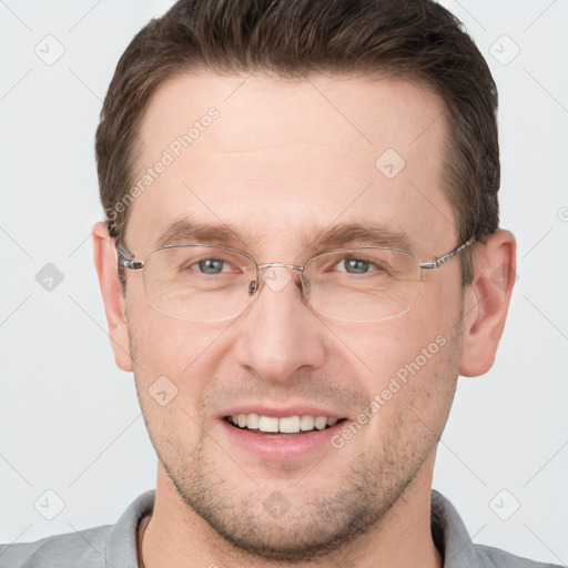 Joyful white adult male with short  brown hair and grey eyes