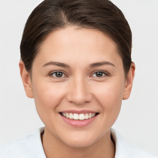 Joyful white young-adult female with short  brown hair and brown eyes