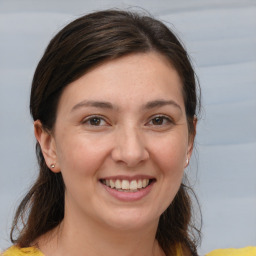 Joyful white young-adult female with medium  brown hair and brown eyes