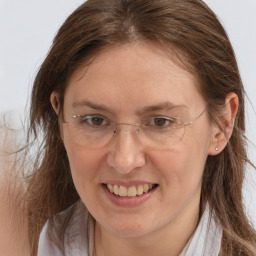 Joyful white adult female with medium  brown hair and brown eyes