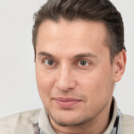 Joyful white adult male with short  brown hair and brown eyes