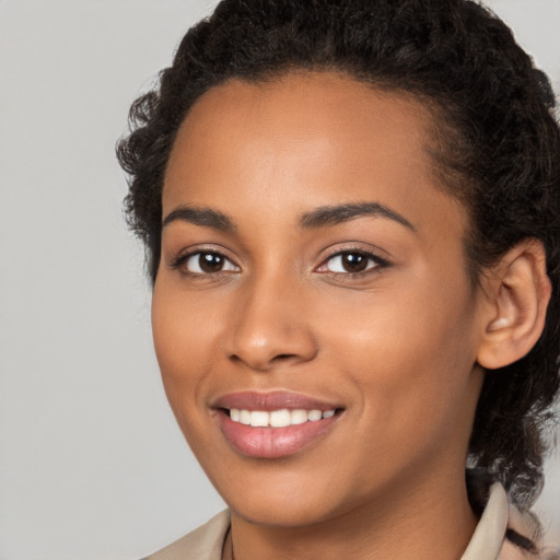 Joyful latino young-adult female with medium  brown hair and brown eyes