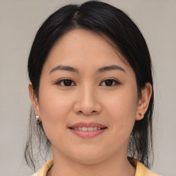 Joyful asian young-adult female with medium  brown hair and brown eyes