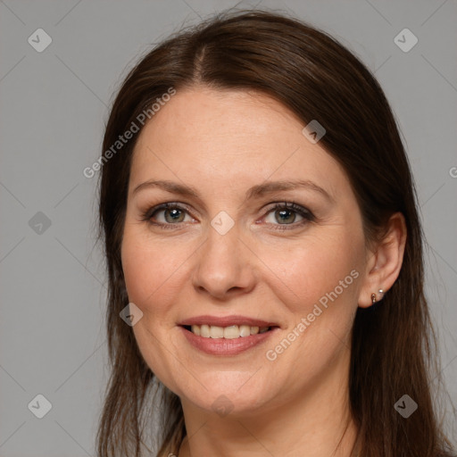 Joyful white adult female with long  brown hair and grey eyes