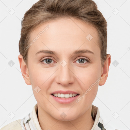 Joyful white young-adult female with short  brown hair and grey eyes