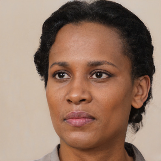 Neutral black adult female with medium  black hair and brown eyes