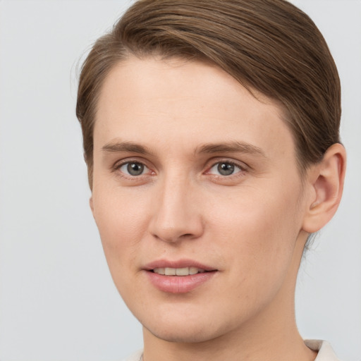 Joyful white young-adult female with short  brown hair and grey eyes