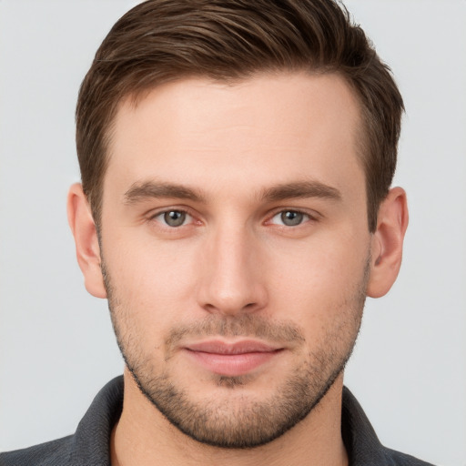 Joyful white young-adult male with short  brown hair and grey eyes