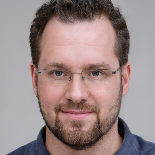 Joyful white adult male with short  brown hair and grey eyes