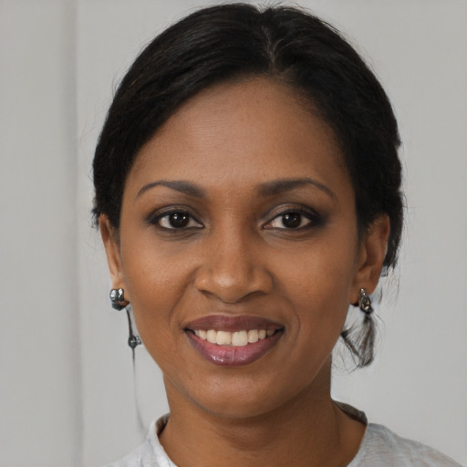 Joyful black young-adult female with medium  black hair and brown eyes