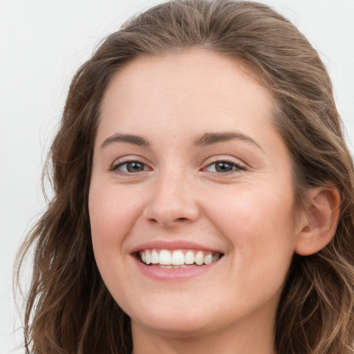 Joyful white young-adult female with long  brown hair and green eyes