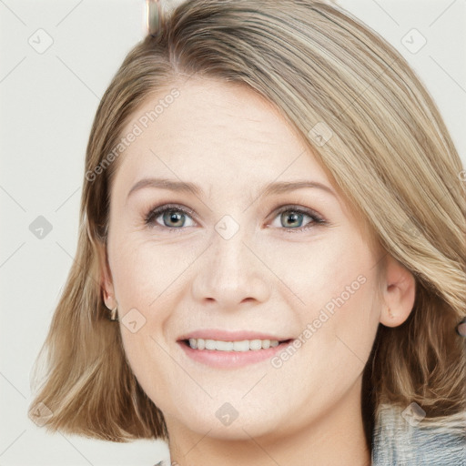 Joyful white young-adult female with medium  brown hair and blue eyes