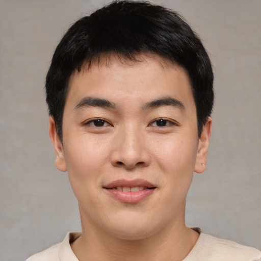 Joyful asian young-adult male with short  black hair and brown eyes