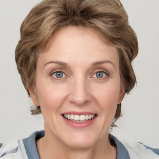 Joyful white adult female with medium  brown hair and blue eyes