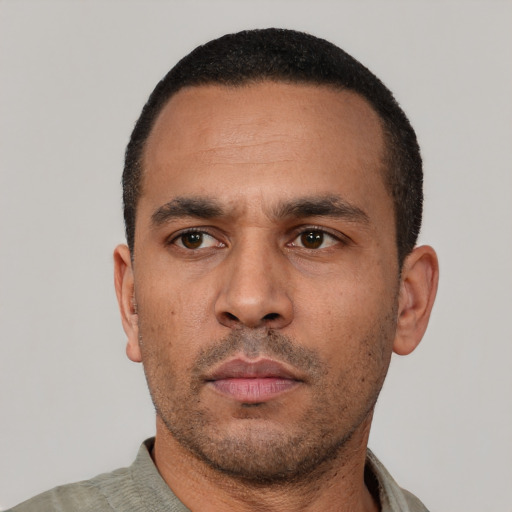 Neutral latino adult male with short  black hair and brown eyes