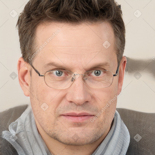 Joyful white adult male with short  brown hair and grey eyes