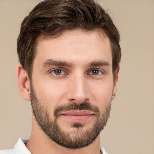 Joyful white young-adult male with short  brown hair and brown eyes