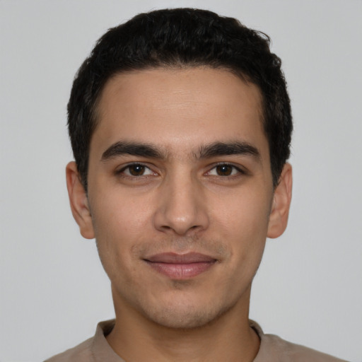 Joyful white young-adult male with short  black hair and brown eyes