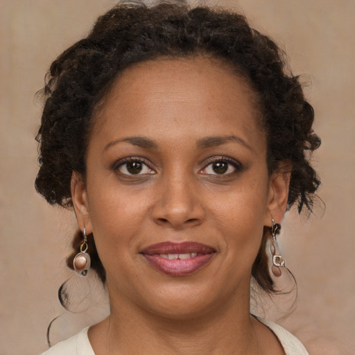 Joyful black young-adult female with medium  brown hair and brown eyes