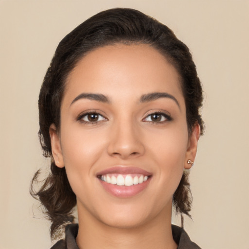 Joyful latino young-adult female with medium  brown hair and brown eyes