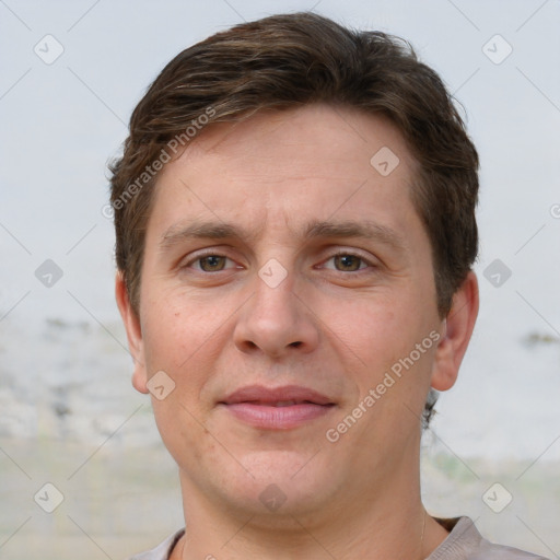 Joyful white adult male with short  brown hair and grey eyes