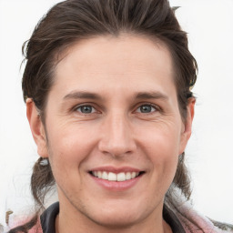 Joyful white young-adult female with medium  brown hair and grey eyes