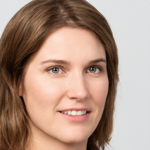 Joyful white young-adult female with long  brown hair and green eyes