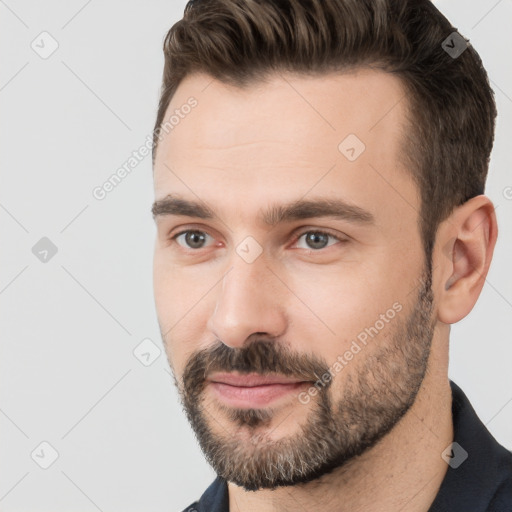 Joyful white adult male with short  brown hair and brown eyes