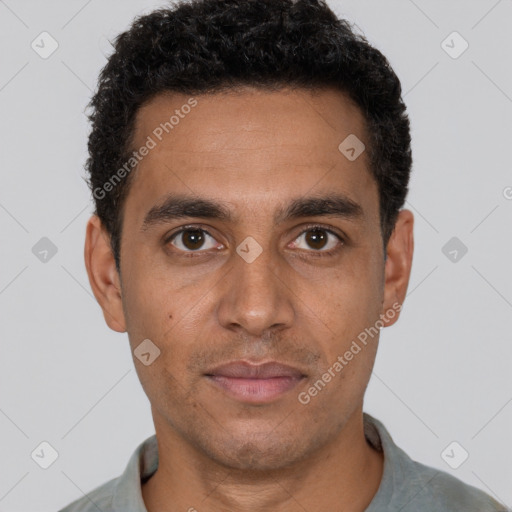 Joyful latino young-adult male with short  brown hair and brown eyes